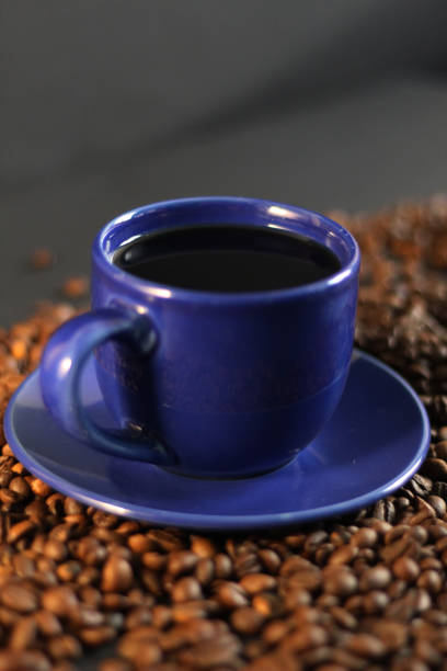 istock Blue coffee cup, roasted coffee beans, black background 1014047794