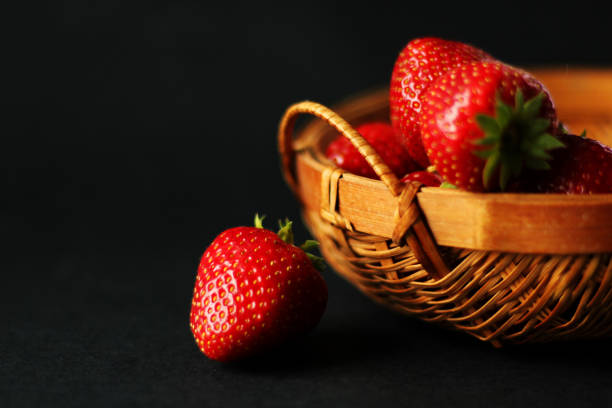 istock Close up on fresh, juicy strawberries, black background, selective focus 1014050098
