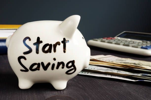 istock Start Saving written on a piggy bank and money. 1014050542