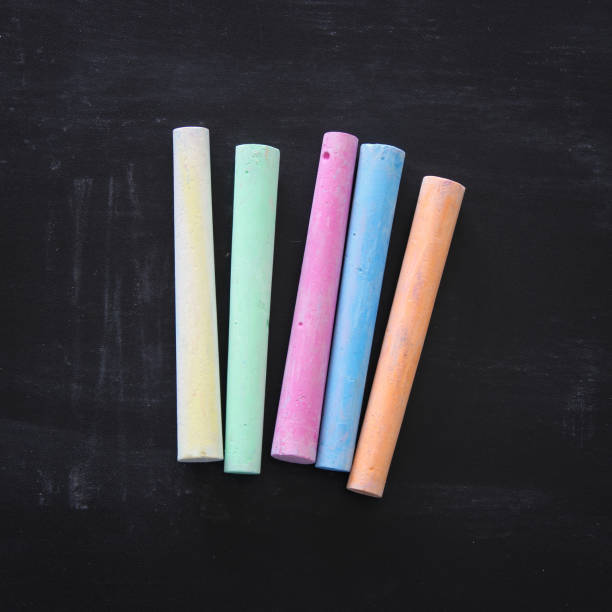 istock Top view of colorful chalks over blackboard background. 1014050962