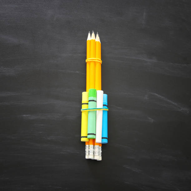 istock Top view of pencils over chalkboard background. 1014050982