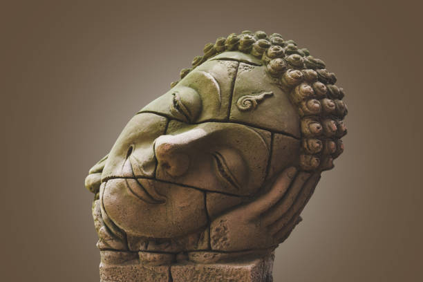 istock Ruin of buddha head statue isolated on white with clipping path 1014056294