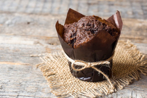 istock Chocolate muffin on wooden background. Copy space 1014059110