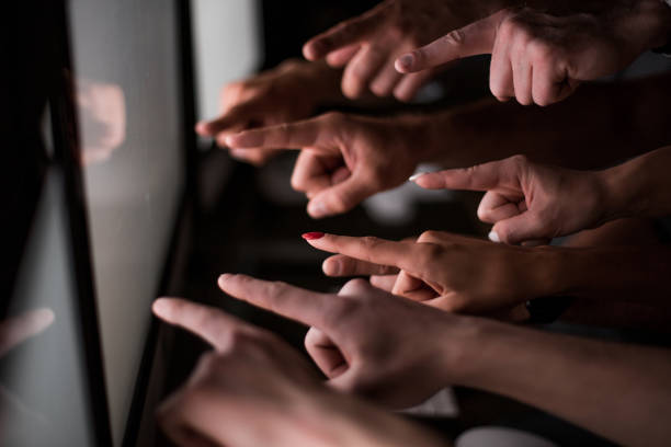 istock business team pointing their fingers at the computer screen 1014059150