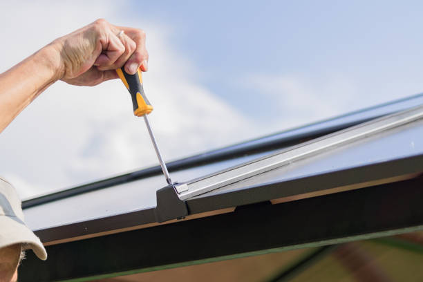 istock screwdriver in males hands. Worker with a hand tool assembling metal construction outdoors 1014059730