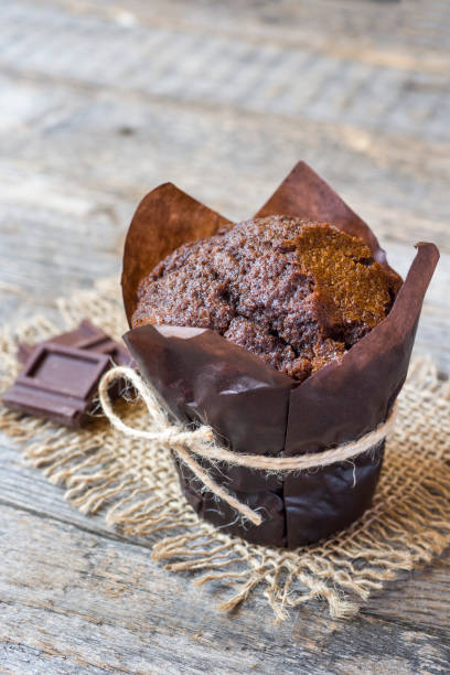 istock Chocolate muffin on wooden background. Copy space 1014059984