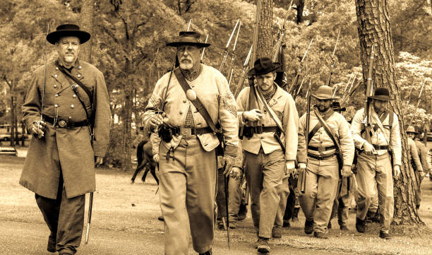 confederate civil war reenactors on the march in sepia - confederate soldier imagens e fotografias de stock