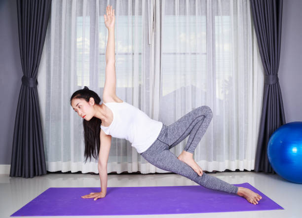 istock woman doing yoga exercise isolated on white background 1014065162
