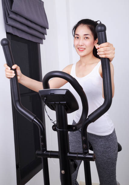 istock sporty woman doing exercises with elliptical trainer 1014068722