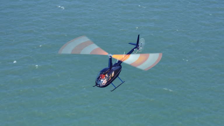 AERIAL Helicopter flying above then sea on a sunny day