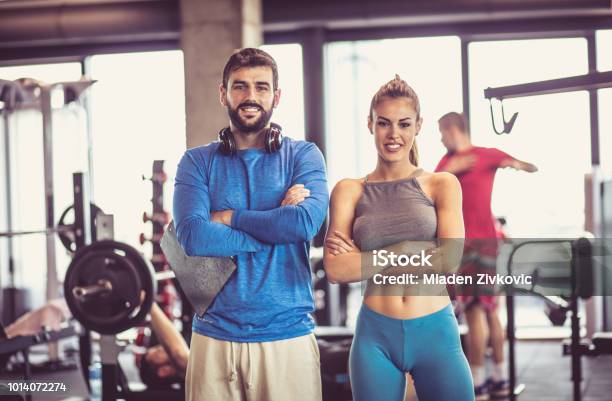 Portrait Of Smiling Man And Woman In Gym Stock Photo - Download Image Now - Fitness Instructor, Couple - Relationship, Instructor