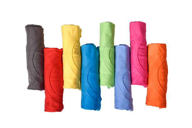 Row of colorful rolled clothes Row of colorful rolled clothes isolated over white background rolled up stock pictures, royalty-free photos & images