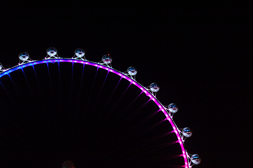 Beautiful multicolored ferris wheel against the background of the night sky