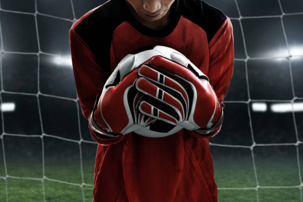 istock Soccer goalkeeper catches the ball 1014077494