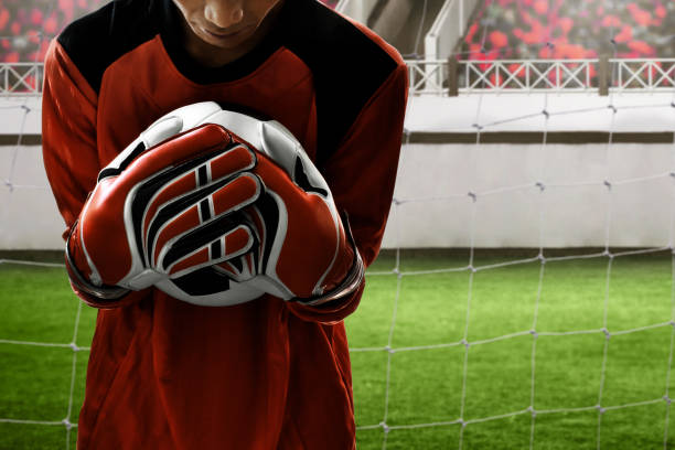 istock Soccer goalkeeper catches the ball 1014077508