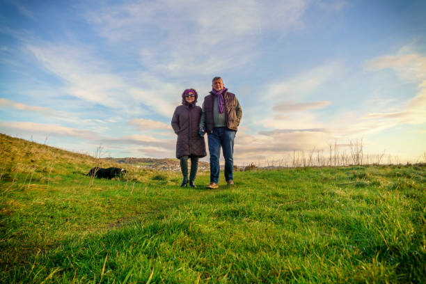 istock Senior couple walking on countryside path in winter 1014092848