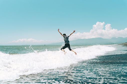 A woman jumping on the beach