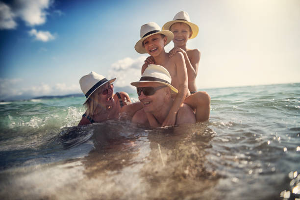 istock Grandparents playing with grandsons in sea 1014098684