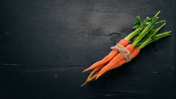 istock Fresh Carrot. Fresh vegetables. On a wooden background. Top view. Copy space. 1014107678