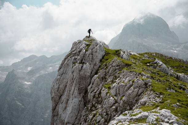 istock Success - male hiker stands on a rock 1014120164