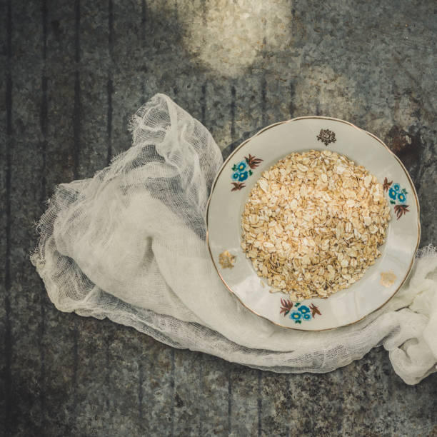 porridge - a portion a breakfast of oat flakes with honey, apples. food background