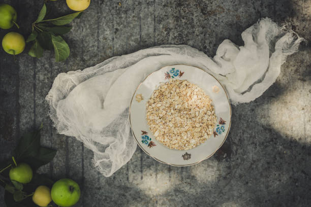 porridge - a portion a breakfast of oat flakes with honey, apples. food background