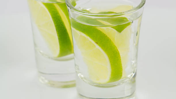 Two shots of vodka or tequila with lime
