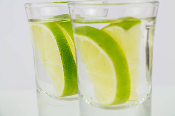 istock Two shots of vodka or tequila with lime 1014126270