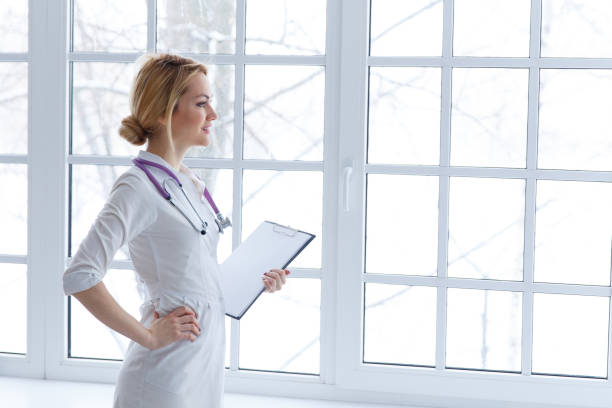 istock Happy smiling female doctor with clipboard 1014126812