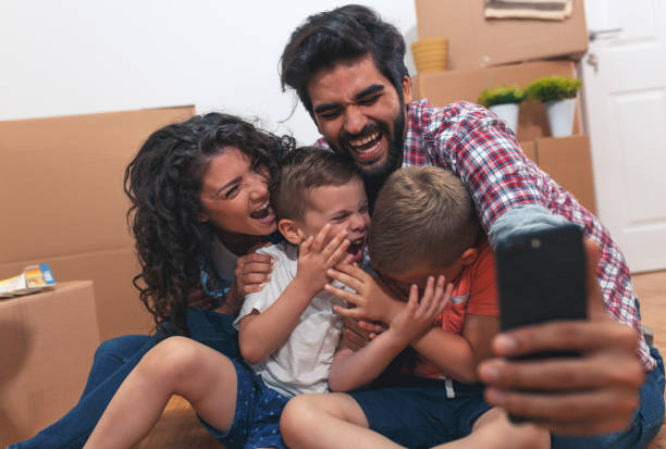 istock Happy young family having fun while moving into their new home. 1014129926