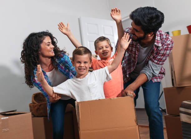 istock Happy young family having fun while moving into their new home. 1014129928