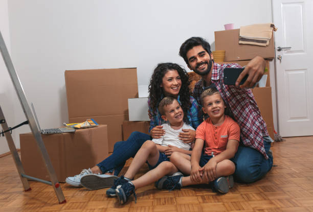 istock Happy young family having fun while moving into their new home. 1014130098
