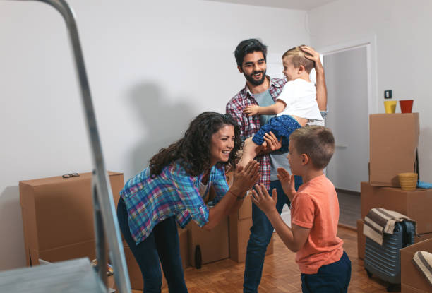 istock Happy young family having fun while moving into their new home. 1014130416