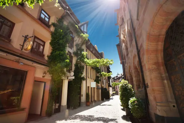 Narrow street of Freiburg im Breisgau at sunny day, Germany, Europe