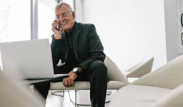 istock Mature businessman working in office lobby 1014139614