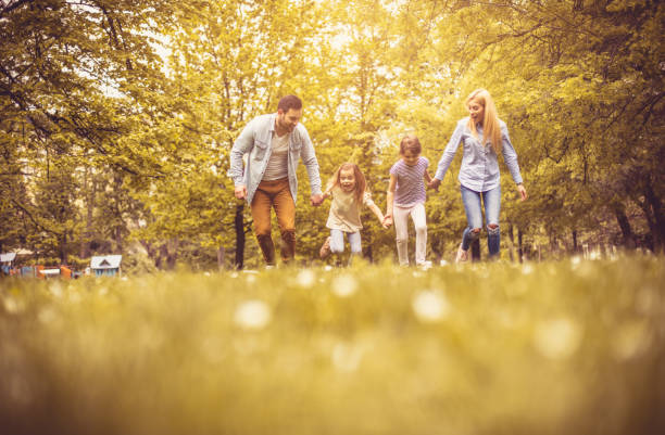 istock Family running trough park. 1014141968