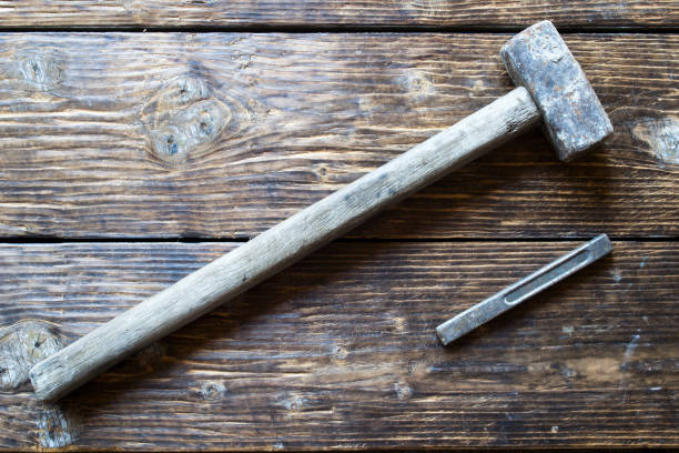 istock A sledge hammer on a wooden table. 1014150388