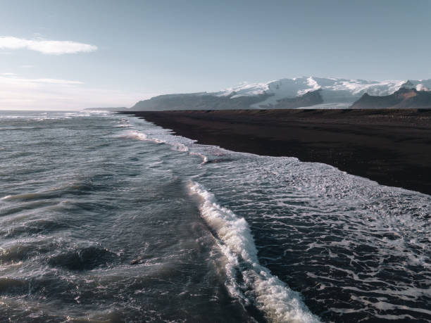 istock Drone view at Iceland black beach with mountains at background 1014151926