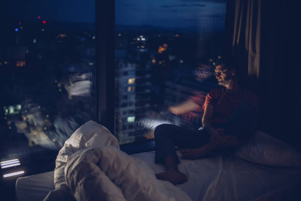 istock Sitting by the window at night 1014158858