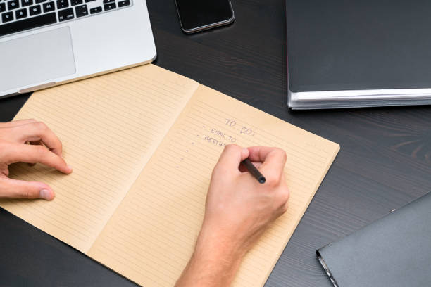 istock Overhead view of office table with blank notebook and pen, computer keyboard, tablet pc and smartphone. copy space for text, business office workplace 1014160674