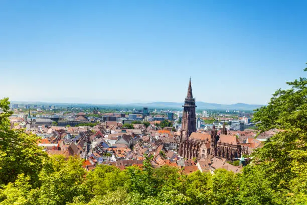 Freiburg im Breisgau cityscape with Munster towers against blue sky, Germany, Europe