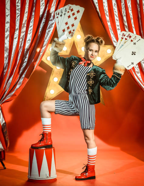 istock Young Girl Magician with Playing Cards 1014165036