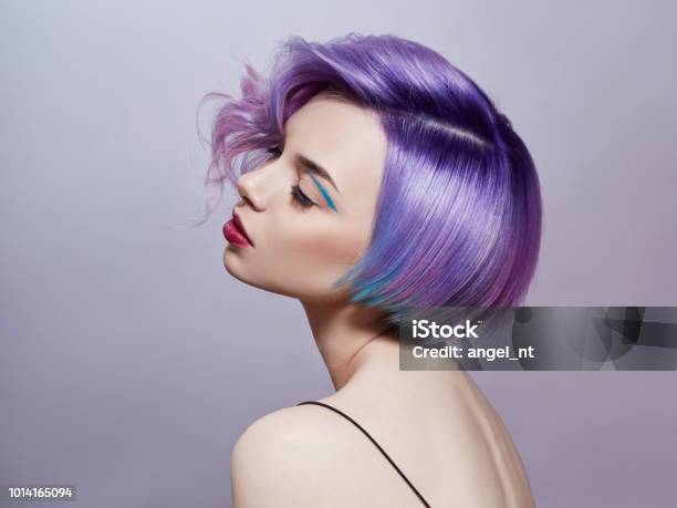 Portrait Of A Woman With Bright Colored Flying Hair All Shades Of Purple Hair Coloring Beautiful Lips And Makeup Hair Fluttering In The Wind Sexy Girl With Short Hair Professional Coloring Stock Photo - Download Image Now
