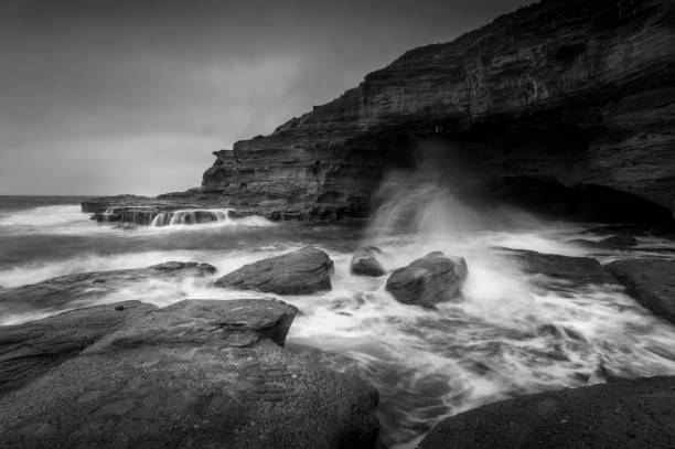 istock Bulgo Beach cave with ocean waves crashing over rocks 1014168988