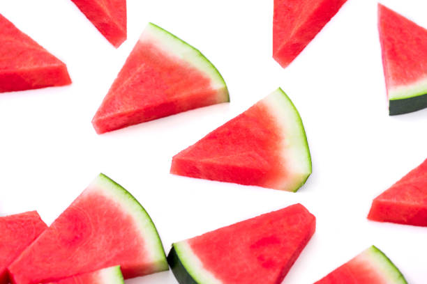 istock Watermelon pieces pattern. Sliced watermelon isolated on white  background. Flat lay 1014173584