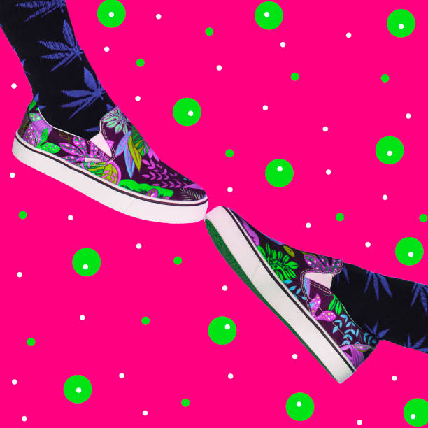 Two feet shoes touch each other.