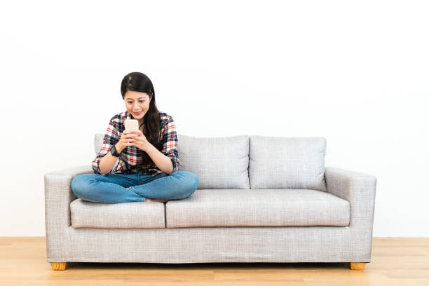 istock smiling elegant woman using mobile smartphone 1014179458
