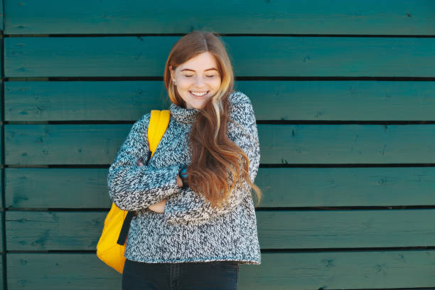 istock Young woman smiling with closed eyes 1014185872