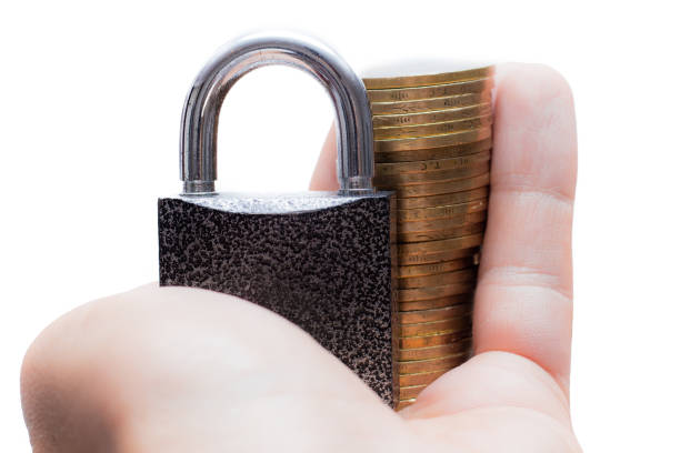 istock Hand holding metal lock and money isolated on white background - Security Concept 1014190062