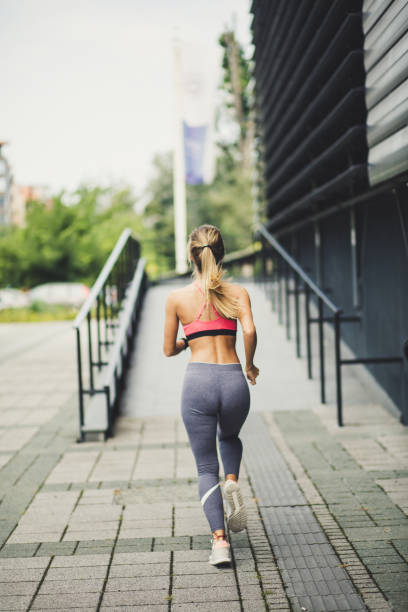 istock Young beautiful blonde women running.   From back. 1014193520